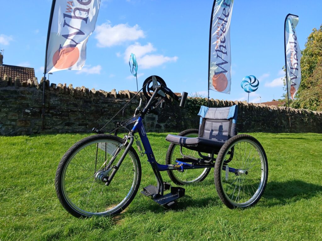 a blue hand-crank tricycle