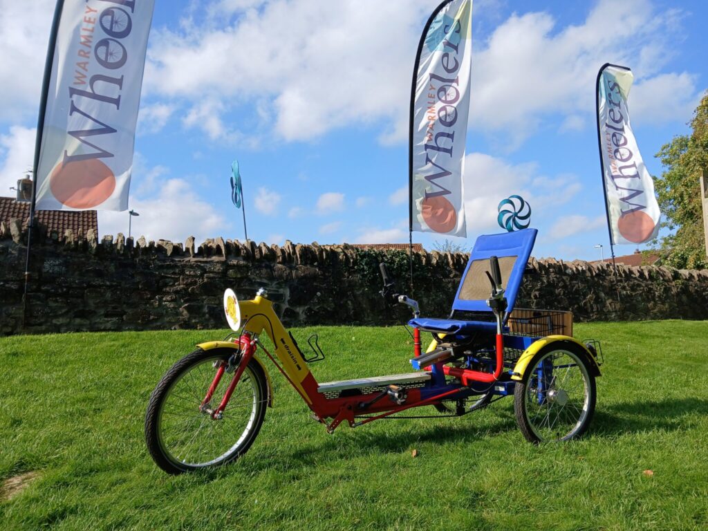 a red and yellow recumbent bicycle