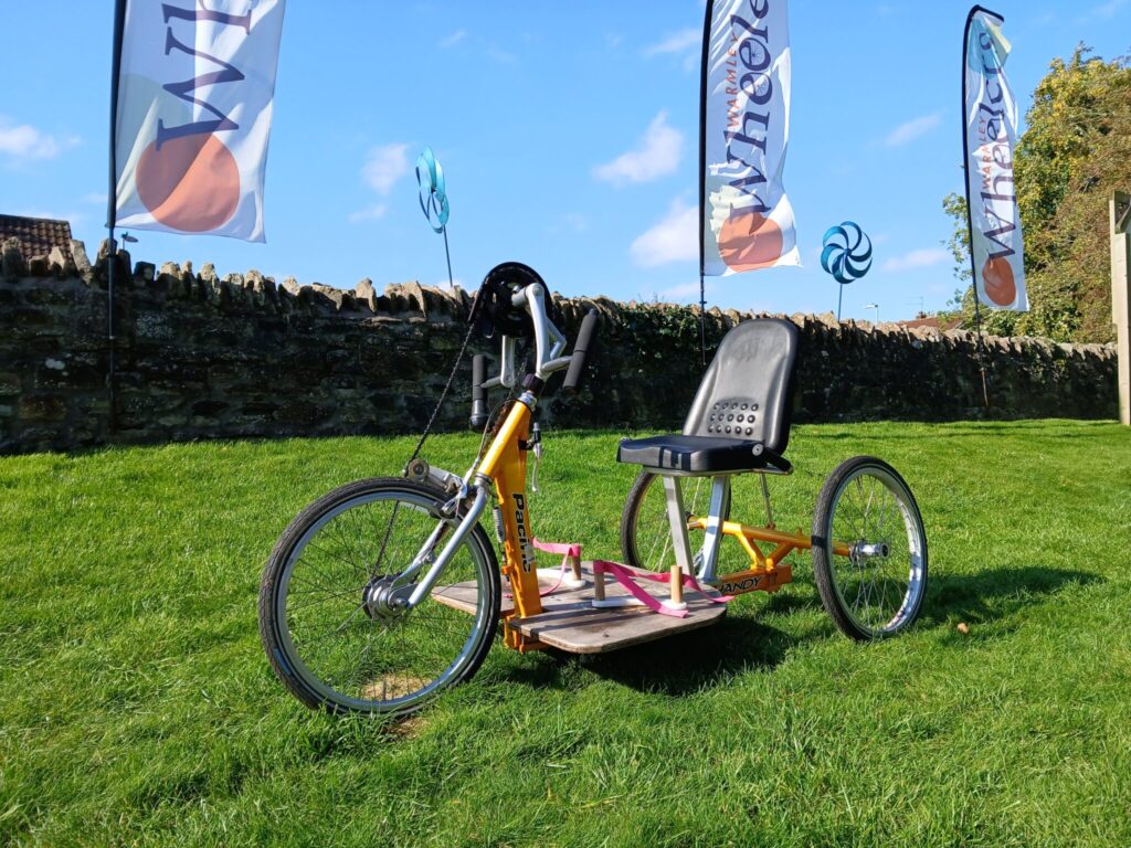 A yellow hand crank bicycle